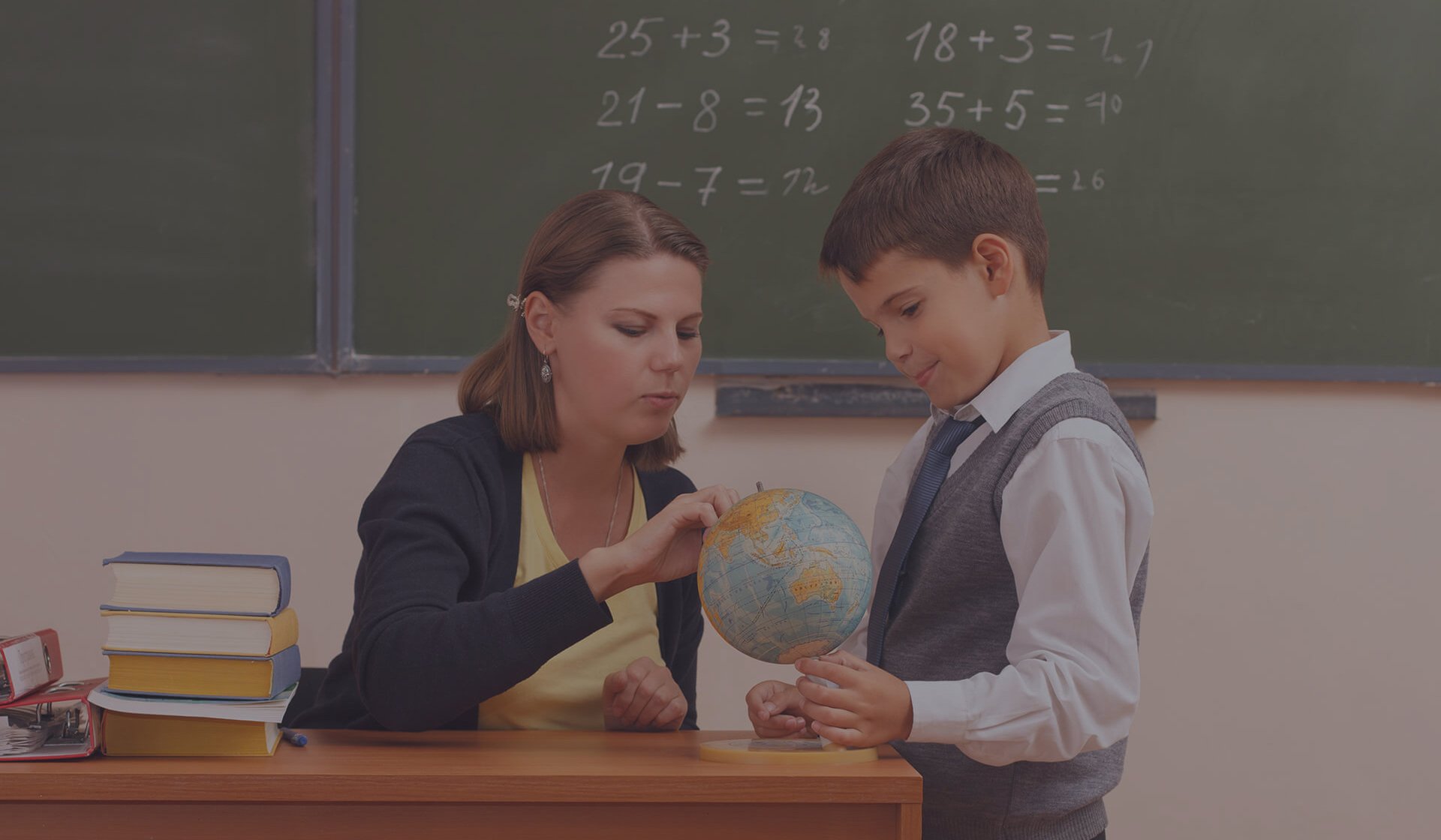 Sustainability in schools - teacher shows student the globe